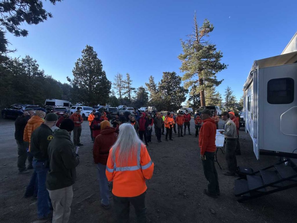 Uniformed members of multiple search teams gathered to hear an incident briefing