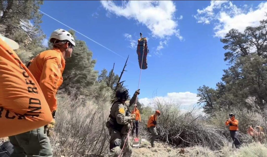 Subjecting being hoisted by helicopter with ground teams manning a tag line